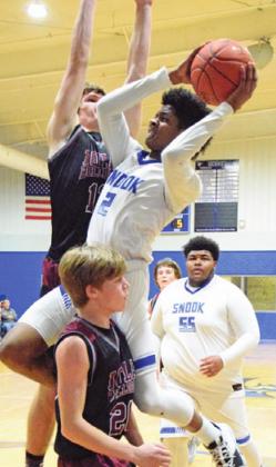 JERMAINE KEARNEY leaps to attempt a basket during the Bluejays&#x2019; game against Iola on Tuesday. -- Tribune photo by Denise Hornaday