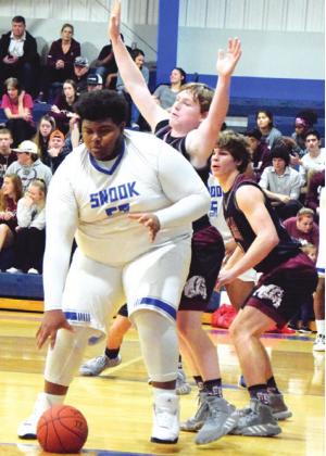 SNOOK&#x2019;S JAMES YOUNG DRIBBLES to set himself up for an easy layup during the Bluejays&#x2019; District 26-2A game against Iola Tuesday night in Snook. -- Tribune photo by Denise Hornaday