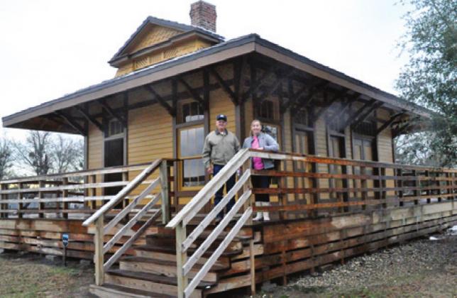 TOMMY RYAN AND Marsha Kocurek stand outside the restored railroad depot in Deanville. -- Tribune photo by Roy Sanders