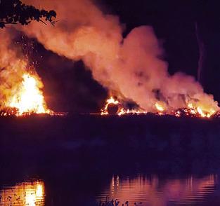 THIS FIRE RAGES Monday night off F.M. 1361 as Snook and Somerville firefighters respond. Pasture land and hay burned. Photo courtesy of Snook Volunteer Fire Department
