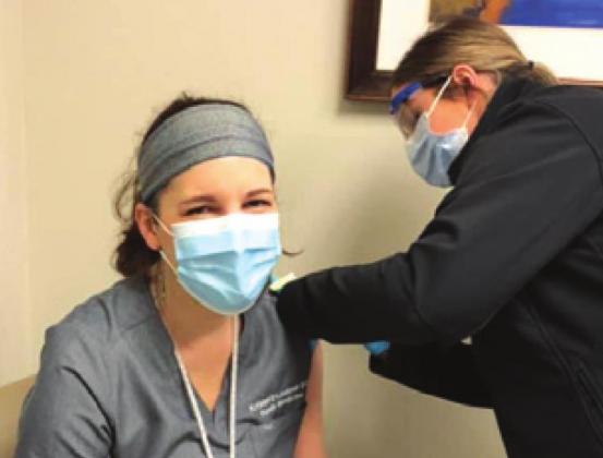 DR. KRISTEL LEUBNER, Burleson County Health Officer, is pictured receiving her first dose of the COVID-19 vaccine.