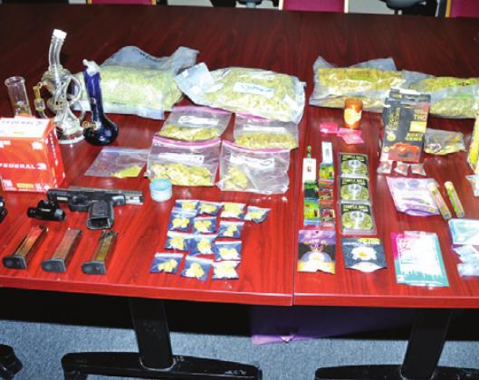DRUGS AND WEAPONS were confiscated by Burleson County sheriff’s deputies after executing a search warrant at a home in the north end of the county. -- Tribune photo by Roy Sanders