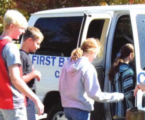 FIRST BAPTIST CHURCH SCHOOL students get into a church van to head back to school after delivering cards and posters made by the school’s students to James Gray to honor him for his service on Veterans Day last week. -- Tribune photo by Denise Hornaday