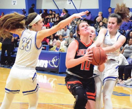 SNOOK’S RILEY GREEN and Avery Kovar attempt to defend Somerville’ Gabby Kovasovic taking a shot during the Snook-Somerville district game last Tuesday. -- Tribune photo by Denise Hornaday