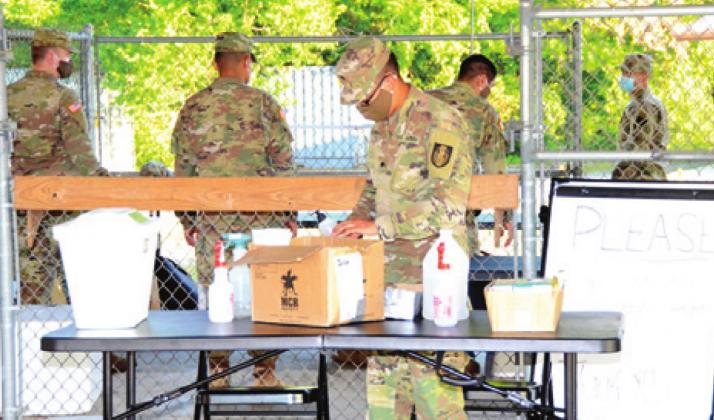 A MOBILE TESTING team works early Tuesday, May 19, at the Burleson County Fairgrounds in Caldwell. The team included members of the Texas Army National Guard. -- Tribune photo by Roy Sanders