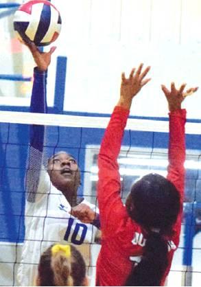 JAIVAN STRINGFELLOW tips the ball over the Burton front line during Snook’s five-set district win on Tuesday night.