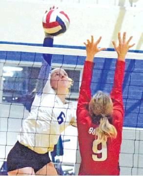 JAYCIE BRISCO HITS the ball over Mycah Simank during the Snook-Burton match on Tuesday. -- Tribune photo by Denise Hornaday