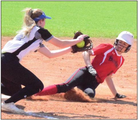 SNOOK’S JAYCIE BRISCO attempts to tag out an Iola runner at third base during a game in mid-March. The UIL recently released the 2020-2021 softball alignments. -- Tribune photo by Denise Hornaday