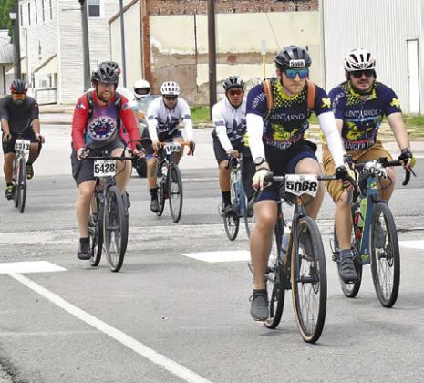 BIKERS FROM THE MS 150 bike ride make their way into Somerville on Sunday, April 28, headed for F.M. 1361 and on to College Station.