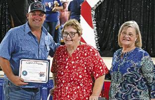MELYNDA GIESENSCHLAG and Gayla Townsend with the Burleson County Historical Commission recognized the Burleson County Fair Association on Sunday prior to the Baked Goods auction for the 2026 fair’s theme celebrating the United States’ 250th birthday. Tribune photo by Denise Squier
