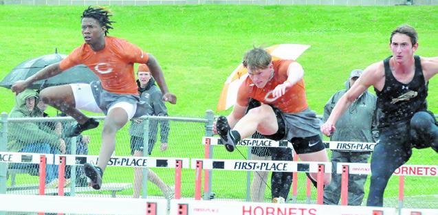CALDWELL’S JIMMY Kearney and Corbin Stewart compete in boys hurdles at last week’s Happy Skrabanek Relays in Caldwell. See story inside. -- Tribune photo by Denise Squier