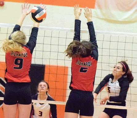 MADDIE KNOX smashes the ball through Richards’ Emme Loman and Laney Stange during the Lady Yeguas’ win on Friday night. Knox had eight kills in the match. -- Tribune photo by Denise Hornaday