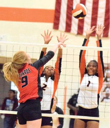 SOMERVILLE’S RAMAYA CARTER and Xadria Martin reach to block a hit from Richards’ Emme Loman during the Lady Yeguas’ win over Richards on Friday night. -- Tribune photo by Denise Hornaday