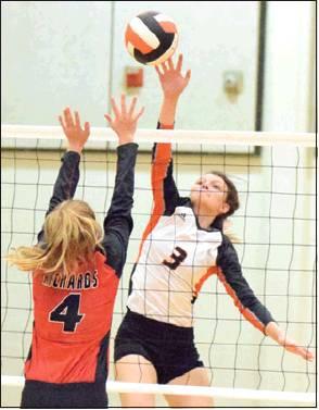 EMMA KOVASOVIC hit the ball over Richards’ Kylie Bates during Somerville’s win on Friday. -- Tribune photo by Denise Hornaday