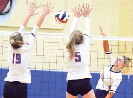 CALDWELL’S MARLEY MAURER hits the ball through the block attempts from Liberty Hill’s Ailie Hair and Emma Becker. Maurer had 15 kills in the Lady Hornet win. -- Tribune photo by Denise Hornaday