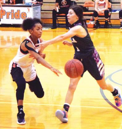 SOMERVILLE’S RA’MAYA CARTER passes the ball to a teammate during the Lady Yeguas’ win over Iola last Tuesday. Carter led Somerville in scoring with 19 points. -- Tribune photo by Denise Squier