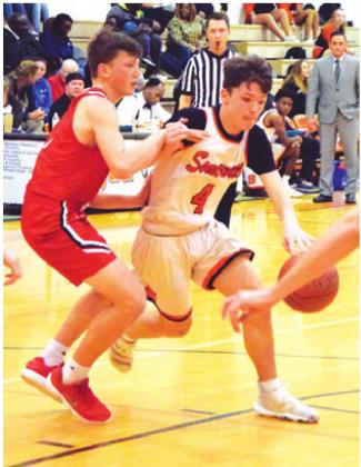 JOHNNY LEGG dribbles around a Burton defender to set up a pass during Somerville’s win Friday. -- Tribune photo by Denise Hornaday