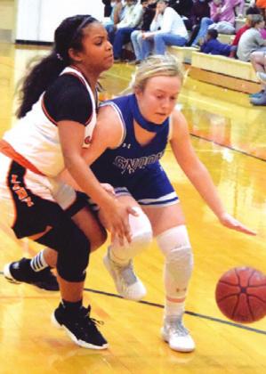 SNOOK’S KYLEIGH Hruska tries to dribble past Somerville’s Jazmine Jackson during the Snook-Somerville game last Tuesday night.