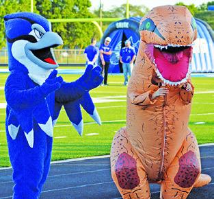THE BLUEJAY and a local dinosaur had fun at last week’s “Meet the Bluejays” at Bluejay Stadium in Snook. Tribune photo by Kimberly Hutcheson