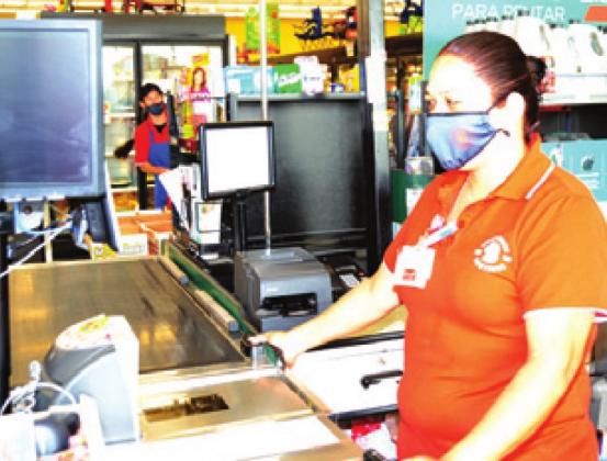 INASIA ARGUELLO wears a mask while working at Brookshire Brothers in Caldwell.