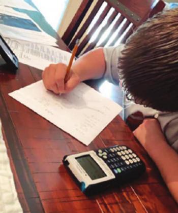 CALDWELL NINTH-grader Carson Parker is working on a math problem during the national coronavirus outbreak.