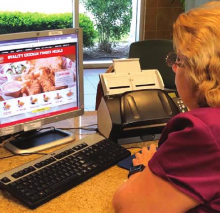 LOCAL RESIDENT Janice Korth Wade orders food online. She said that where she works they try to support Brazos Valley restaurants and businesses that are being affected due to the COVID-19 threat.
