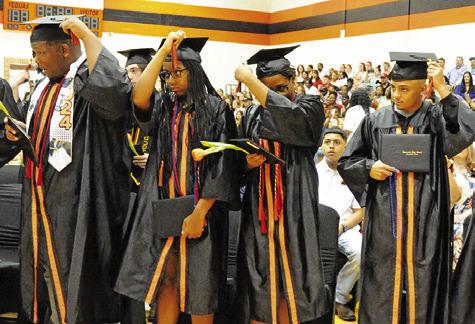 SOMERVILLE HIGH SCHOOL graduates move their tassels at the conclusion of Saturday morning’s graduation ceremony.