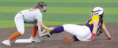 A LA GRANGE PLAYER slides into the glove of Caldwell’s Kelly Urbanovsky at second base, knocking the ball out of the glove, during the Caldwell-La Grange game on Friday. -- Tribune photo by Denise Squier