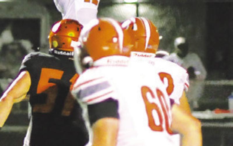 BRAIDE NELSON of Caldwell makes a catch against Smithville last Friday in Smithville. Also pictured are Kyler Roskey and P.J. Supak. -- Tribune photo by Denise Squier