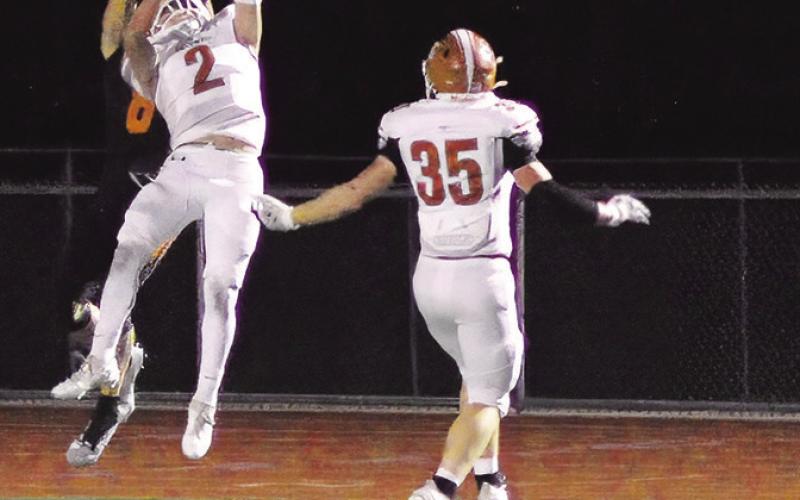 BLANE GARZA OF Caldwell reaches for the ball last Friday at Smithville. Also pictured is Caden Crump. -- Tribune photo by Denise Squier