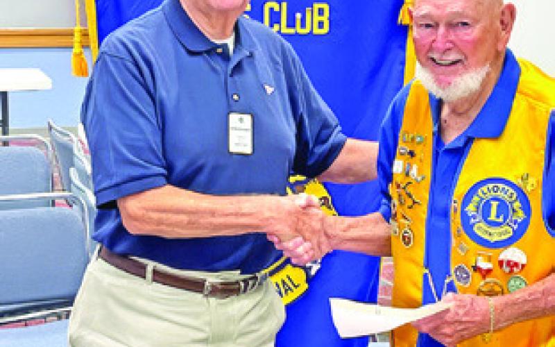 PAST DISTRICT GOVERNOR and Caldwell Men’s Club member Gordon Richardson presents a Milestone Chevron Award for 50 years of service to Clayton Myers. The award included a 50 year pin and a congratulatory letter from Lions International President Patti Hill. Photo courtesy of Robert Lee