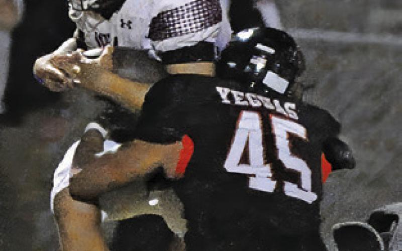 CHRISTOPHER DEERE of Somerville makes a tackle in the Iola game last Friday. Tribune photo by Denise Squier