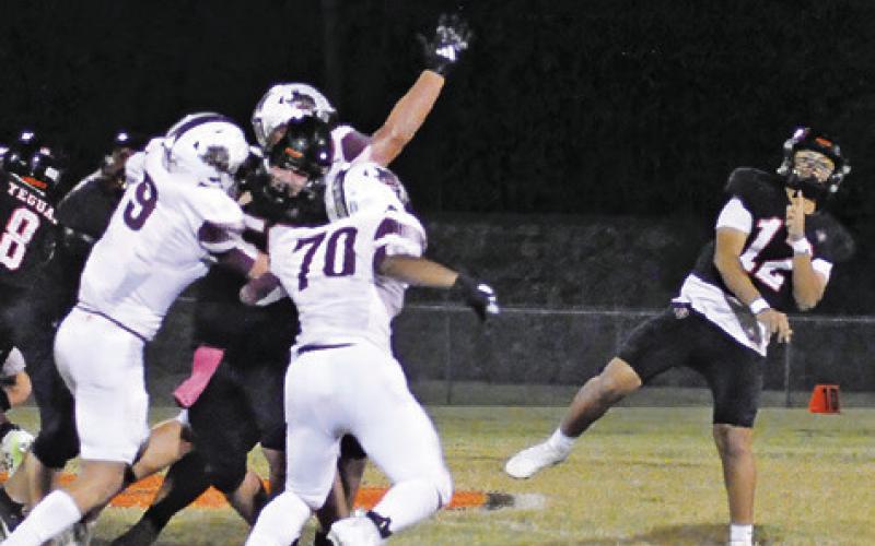 ANDY ESPINOZA OF Somerville hurls this pass against Iola. Tribune photo by Denise Squier