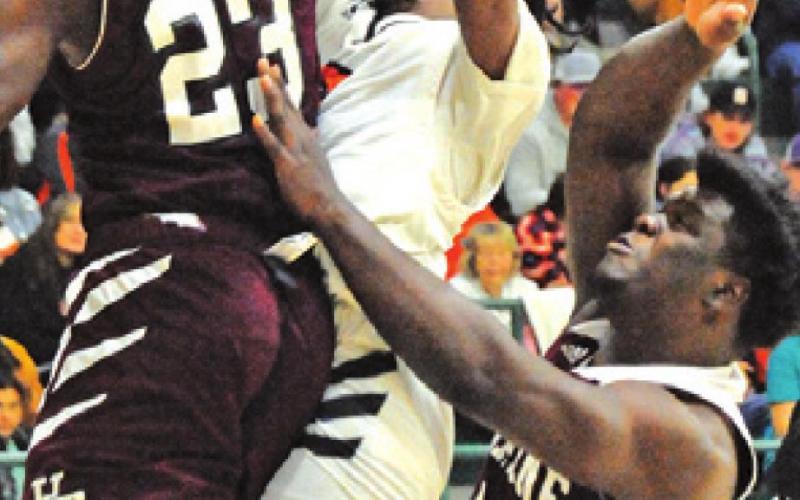 BRANDYN CARTER is about to be fouled while shooting during the Somerville-Hearne playoff game last week at Rudder High School.