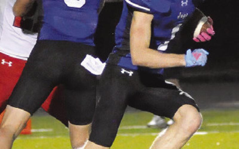 LIAM ZEQUEIRA of Snook runs with the ball against Burton last Friday. Tribune photo by Denise Squier