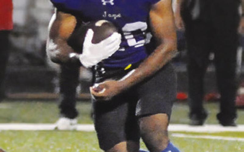 DOMINIC HANKINS carries the ball for Snook against Burton last Friday. Tribune photo by Denise Squier