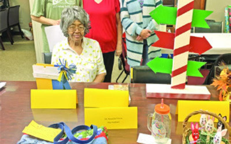 BURLESON COUNTY EEA Cultural Arts Competition Chair Audrey Swain (seated) and her committee members Karen Gaas, Tammy Qualls-Tucker and Debbie Abbott are pictured with some of the entries submitted by EEA Club members for their Burleson EEA Cultural Arts Competition held Feb. 21.
