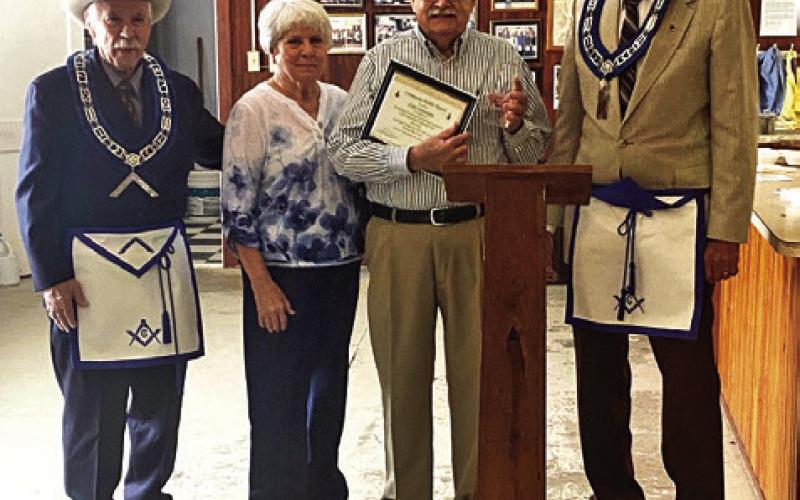 CARLCUMMINSRECEIVED THE prestigious Community Builder award at the Lee Scott Masonic Lodge’s March 15 gathering. Pictured, from left, Jack Womack, WM, Ruth Cummins, Carl Cummins and Jim Braml, PM.