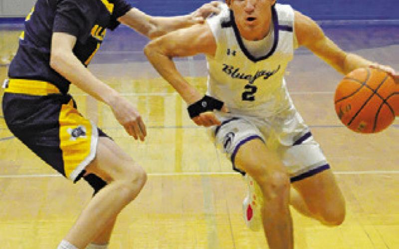 SNOOK’S BRETT Withem dribbles the ball past this Allen Academy defender. Tribune photo by Denise Squier