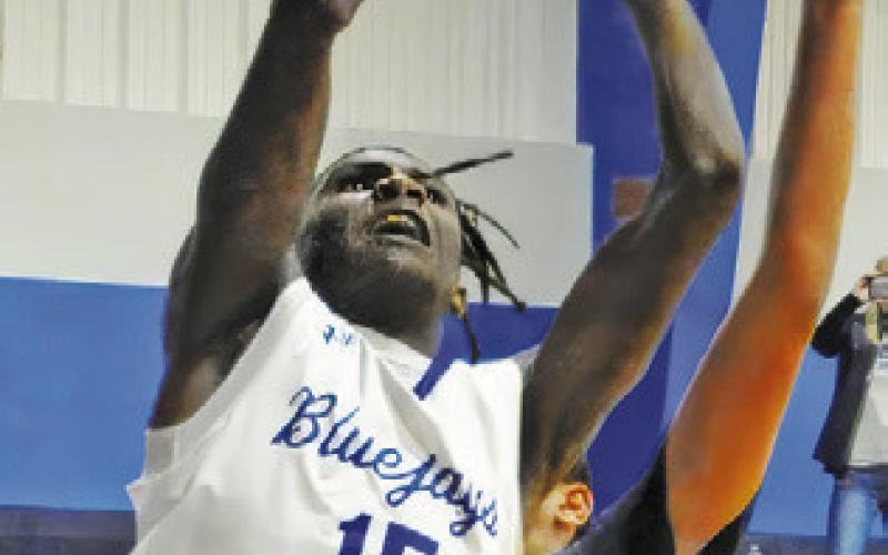 BUD MOORE of Snook takes a shot against Allen Academy. Snook won 78-19. Tribune photo by Denise Squier