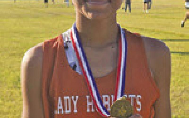 AJRIANA SIMS won the girls race at the district junior high cross country meet last Tuesday.