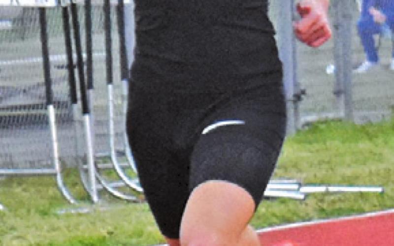 JOHNNY LEGG finishes second in the 400-meter dash at the Koppers Relays.