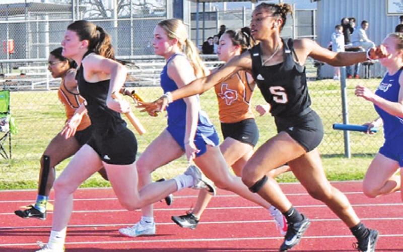 RA’MAYA CARTER (RIGHT) passes the baton to Emma Kovasovic during a Lady Yeguas’ relay win last week at the Koppers Relays.