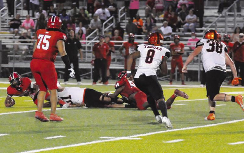 MARTIN ESPINOZA SACKS THE quarterback on the last play as Keke Daniels and Moses Stickel move in. Somerville won 42-41 in overtime to go 3-0 in district play. Tribune photo by Denise Squier