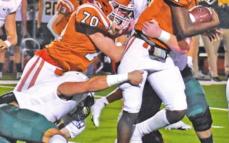 CALDWELL’S JAMAR HEWITT tries to gain more yards while in the grasp of a Bumblebee defender during Friday night’s game. Also pictured is Justin Balcar for Caldwell. -- Tribune photo by Roy Sanders