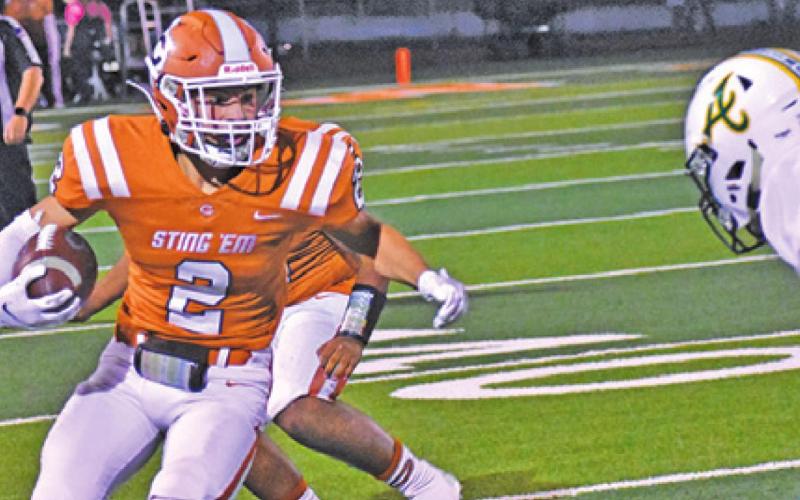 CALDWELL’S BLANE GARZA stares down an Academy defender during the Hornets’ home loss last Friday. -- Tribune photo by Roy Sanders