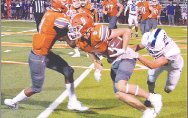 JAMIN WHITE OF Caldwell fights past this Robinson defender in the Hornets 28-0 home loss last Friday. -- Tribune photo by Roy Sanders
