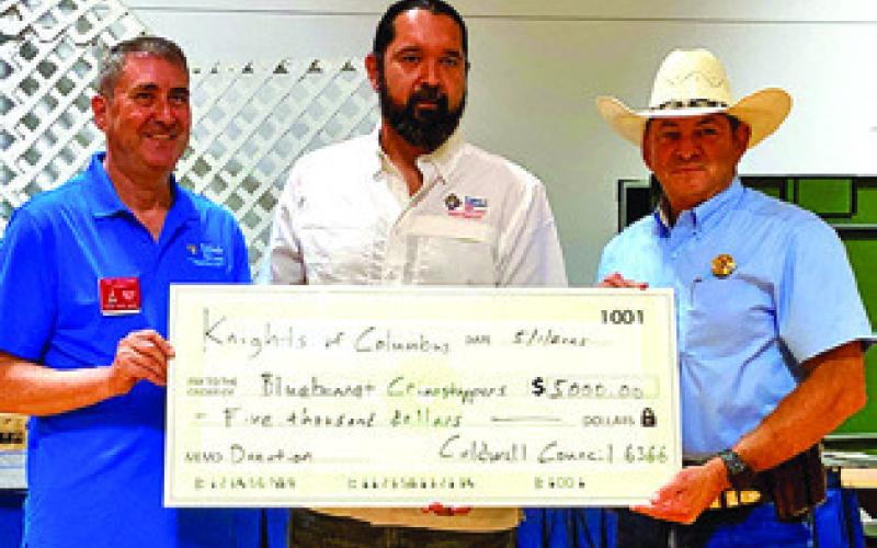 THE CALDWELL KNIGHTSOFCOLUMBUS (KC) presented a check to Bluebonnet Crimestoppers during the annual KC Law Enforcement Dinner. Pictured from left: Tony Zaccagnino, District Deputy, Steven Pipkin, Grand Knight and Chief Deputy Bill Rios, Burleson County Sheriff’s Office. Tribune photo by Sabine Lazo