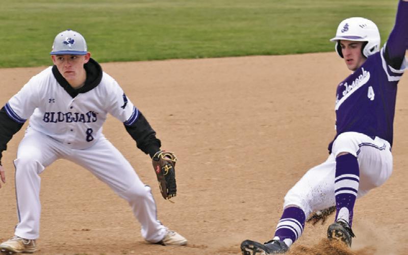 WYATT LOPEZ OF SNOOK is a third base as this St. Joseph baserunner approaches. Tribune photo by Roy Sanders