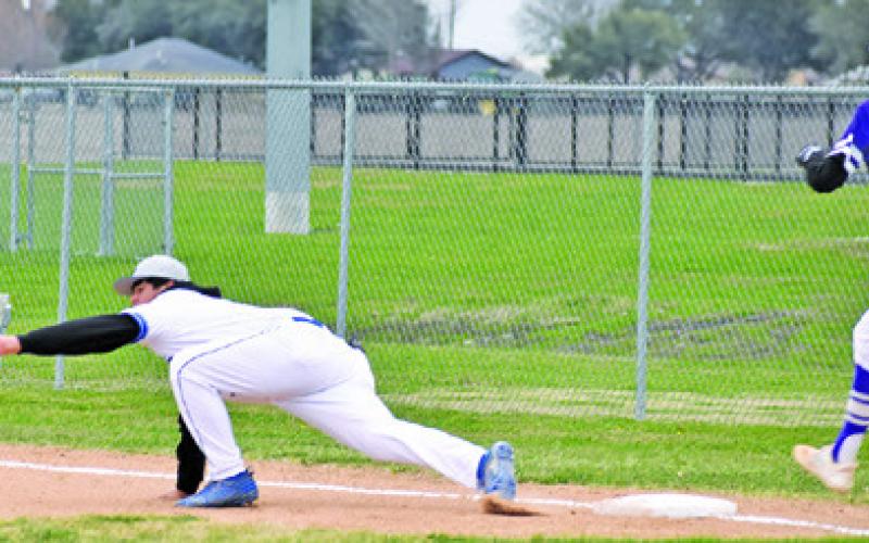 SNOOK FIRST BASEMAN RAMIRO Martinez reachesto make this catch against St. Joseph. Tribune photo by Roy Sanders